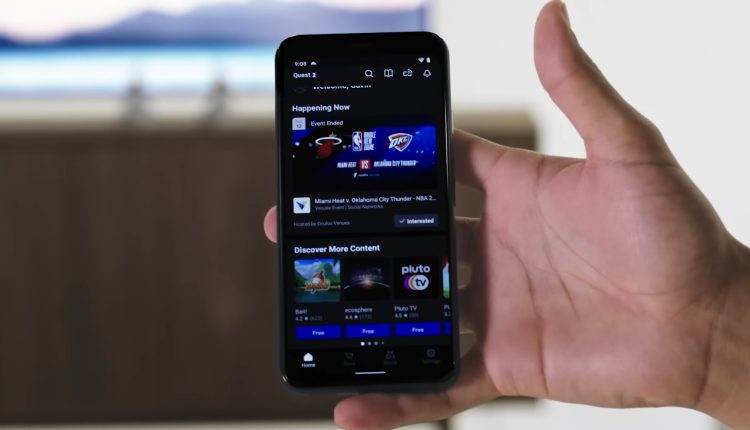A hand holding a smartphone running the Meta Quest app